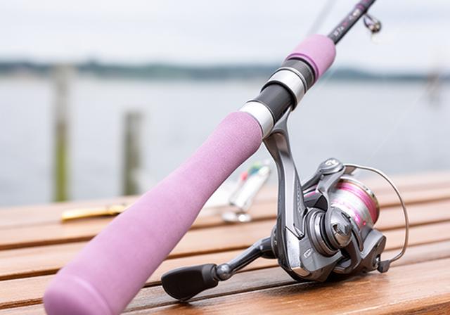 Lightweight fishing rod and reel on a bench near the waterfront with a comfortable oversized grip